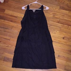 Sleeveless black dress with ruffle skirt